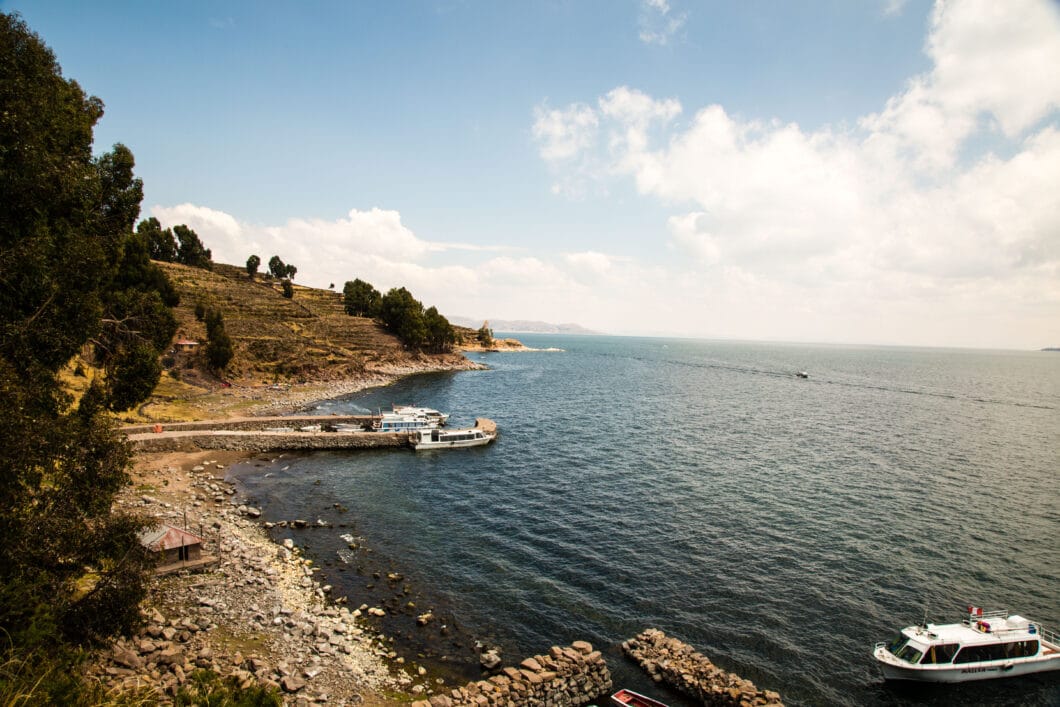 A boat docked on the shore of Taquile Island, Peru.