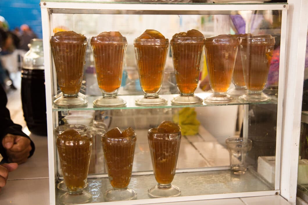 A glass case filled with Gelatina de Pata at San Pedro Market, Peru.