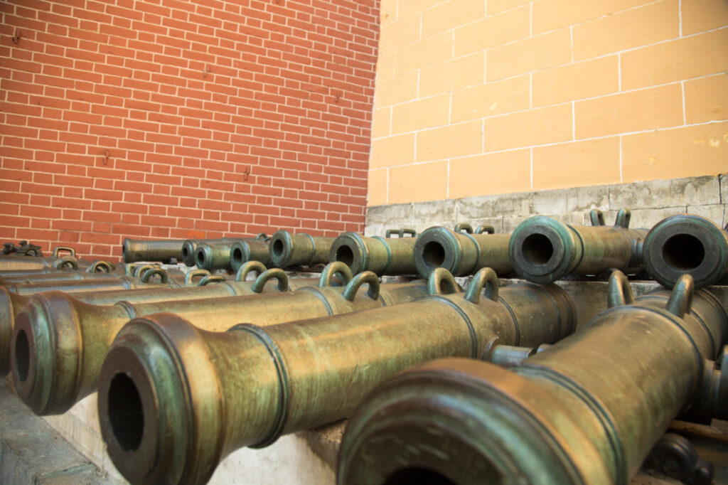 Large metal cannon necks stacked in rows on display at the Kremlin Armoury.