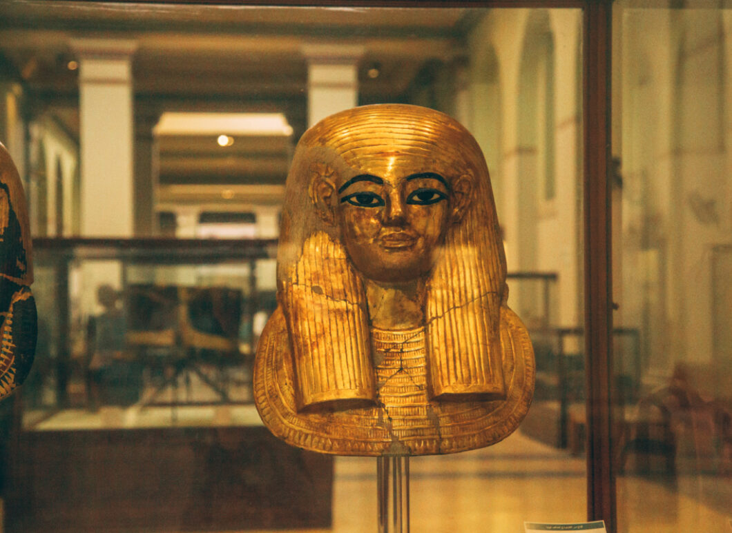 A gold  burial mask used by king tut on display in the Egyptian museum