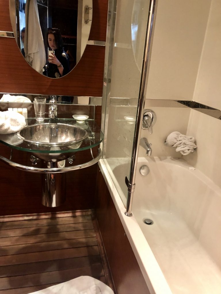 View of a clean bathroom with a bathtub on the Amwaj Living Stone.