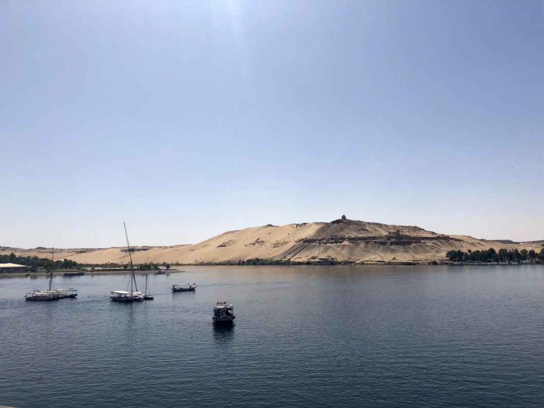 View of the Nile River and a few feluccas from the deck of a Nile River Cruise boat in Egypt