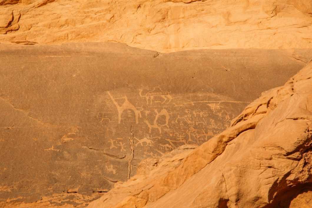 Ancient petroglyphs carved into the desert stones in the Wadi Rum desert in Jordan tell stories from thousands of years ago.