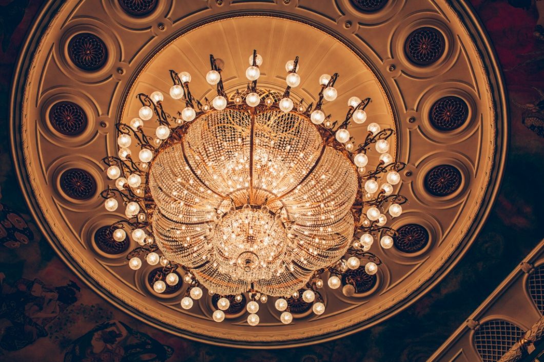 A large crystal chandelier hanging from the ceiling inside the New Stage Theater at the Bolshoi theater in Moscow.