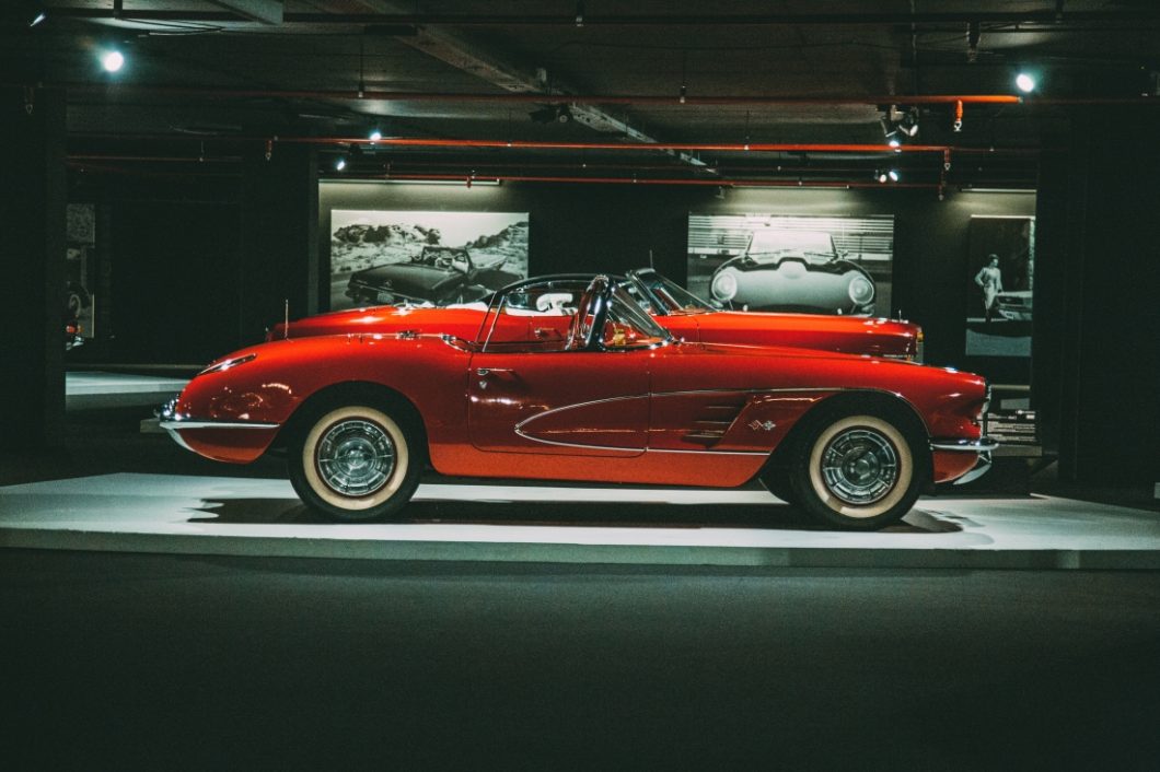 A classic, vintage red Chevrolet Corvette on display at the Heydar Aliyev Center's Classic Car Exhibit in Baku, Azerbaijan