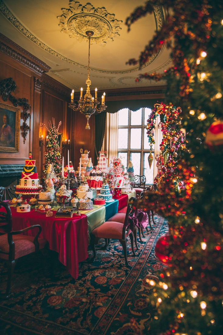 Another view of the Nutcracker dining room, showing a long dining table filled with cakes, desserts, and candies.