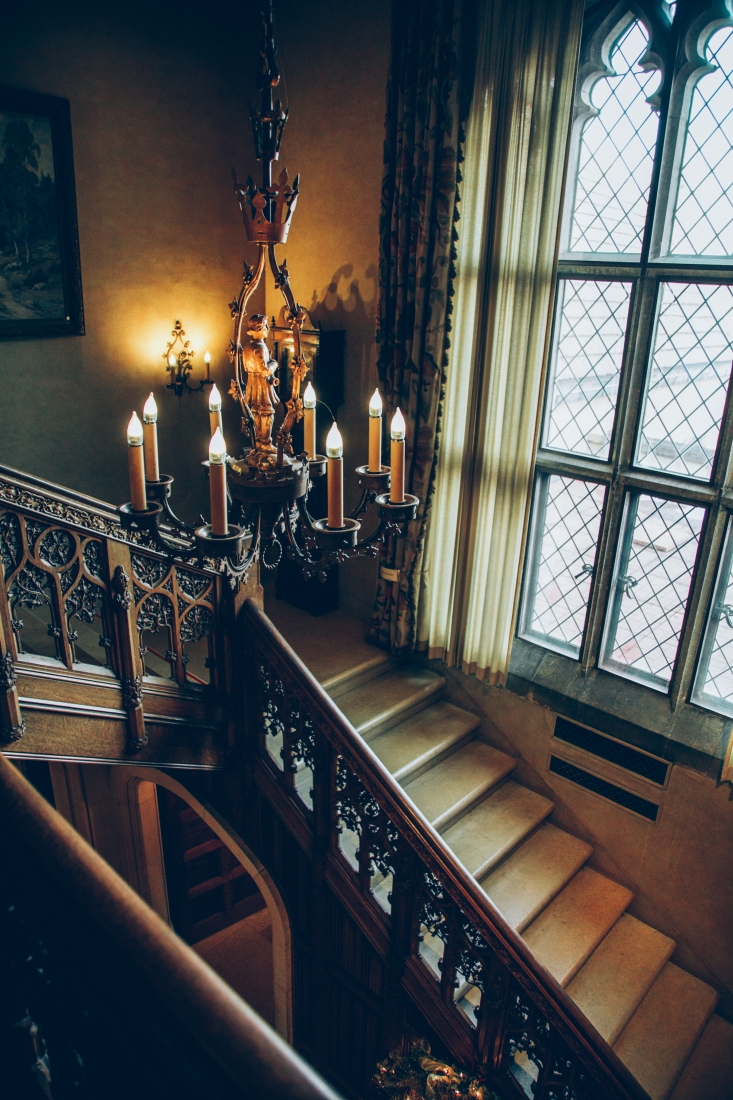 A staircase inside the Paine art center and an elegant hanging chandelier.