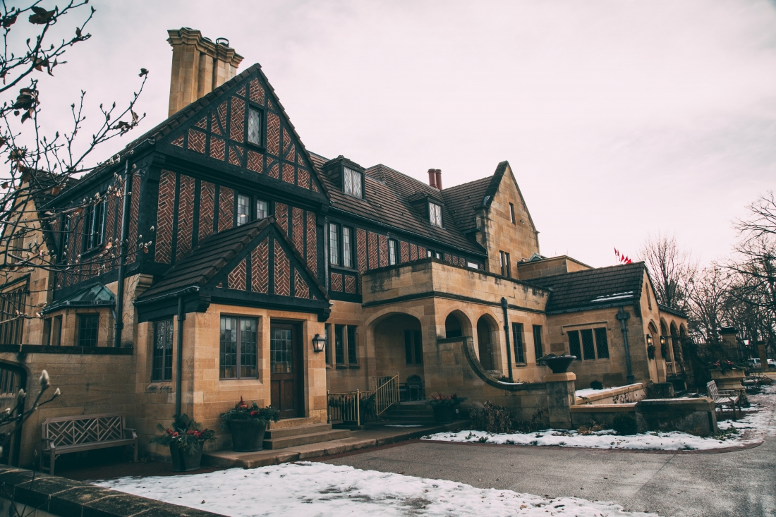 The exterior of the Paine Art Center -- a large three story castle-like building with a brick exterior.