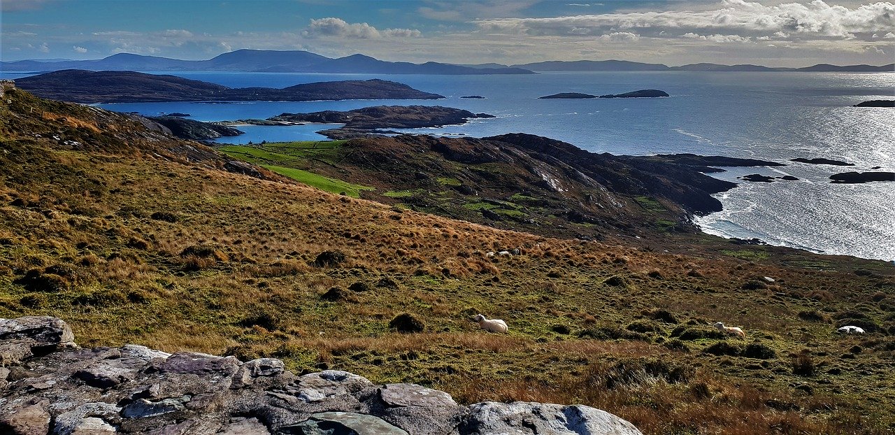 A professional photo of the Ring of Kerry in Ireland - a stunning coastline with hills and gorgeous views of the sea.