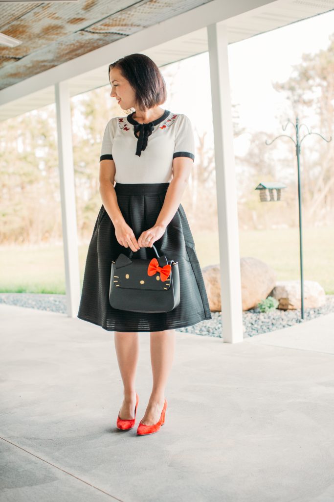 a black midi skirt by Pocket Passionista and Hello Kitty bag