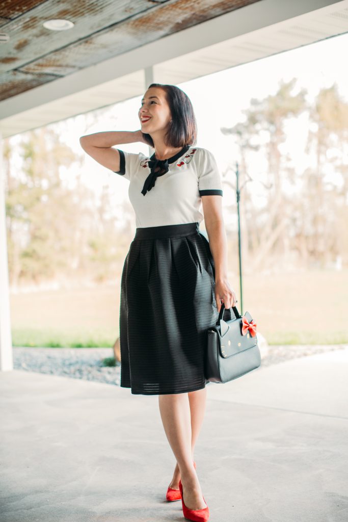 a black midi skirt by Pocket Passionista and Hello Kitty bag