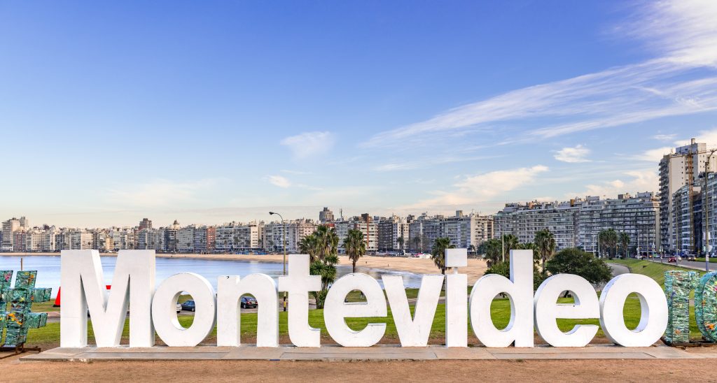 Montevideo sign in white letter in front of the city of Montevideo, Uruguay