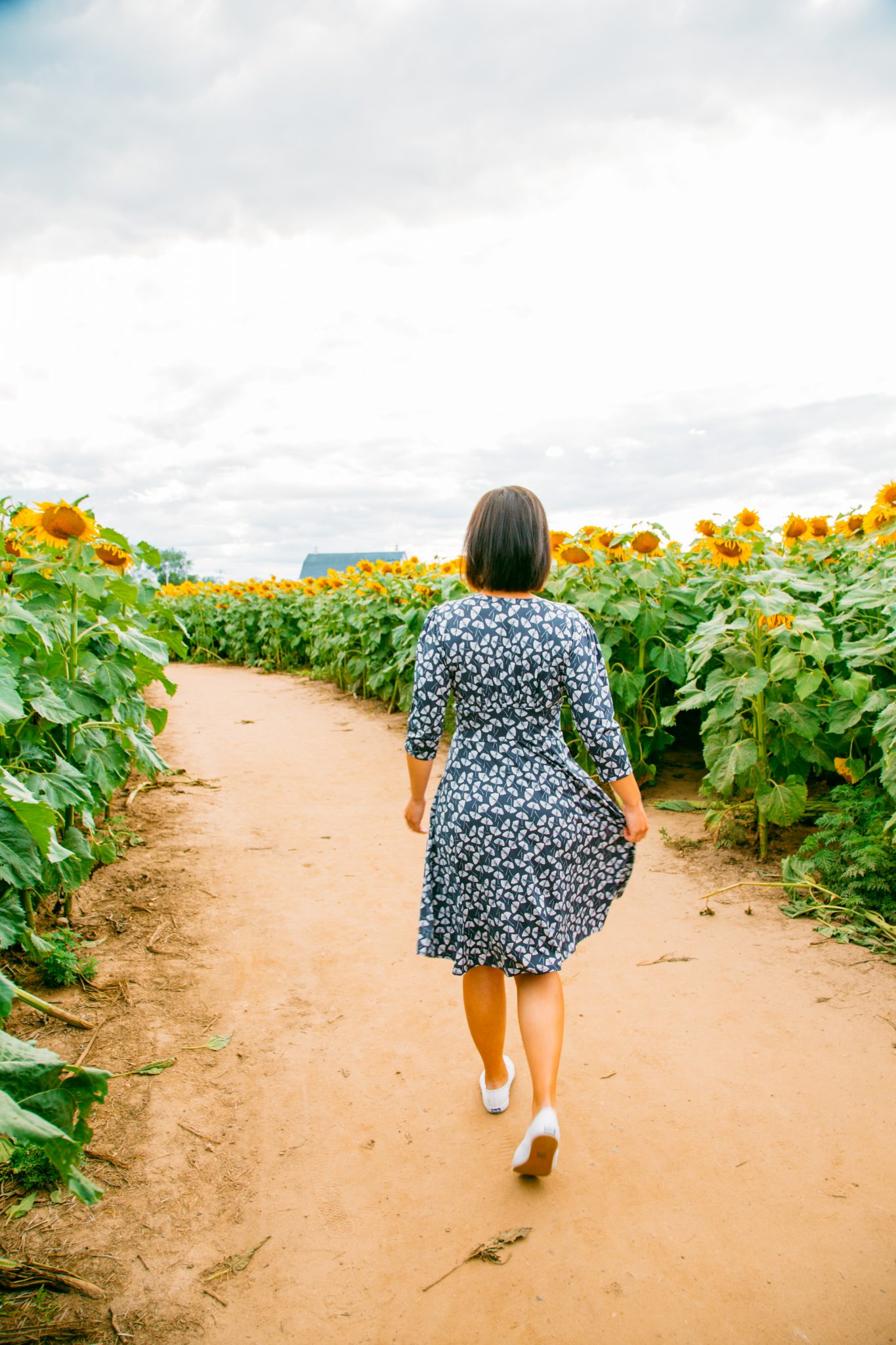 Wearing Karina Megan Dress in a sunflower field in Wisconsin