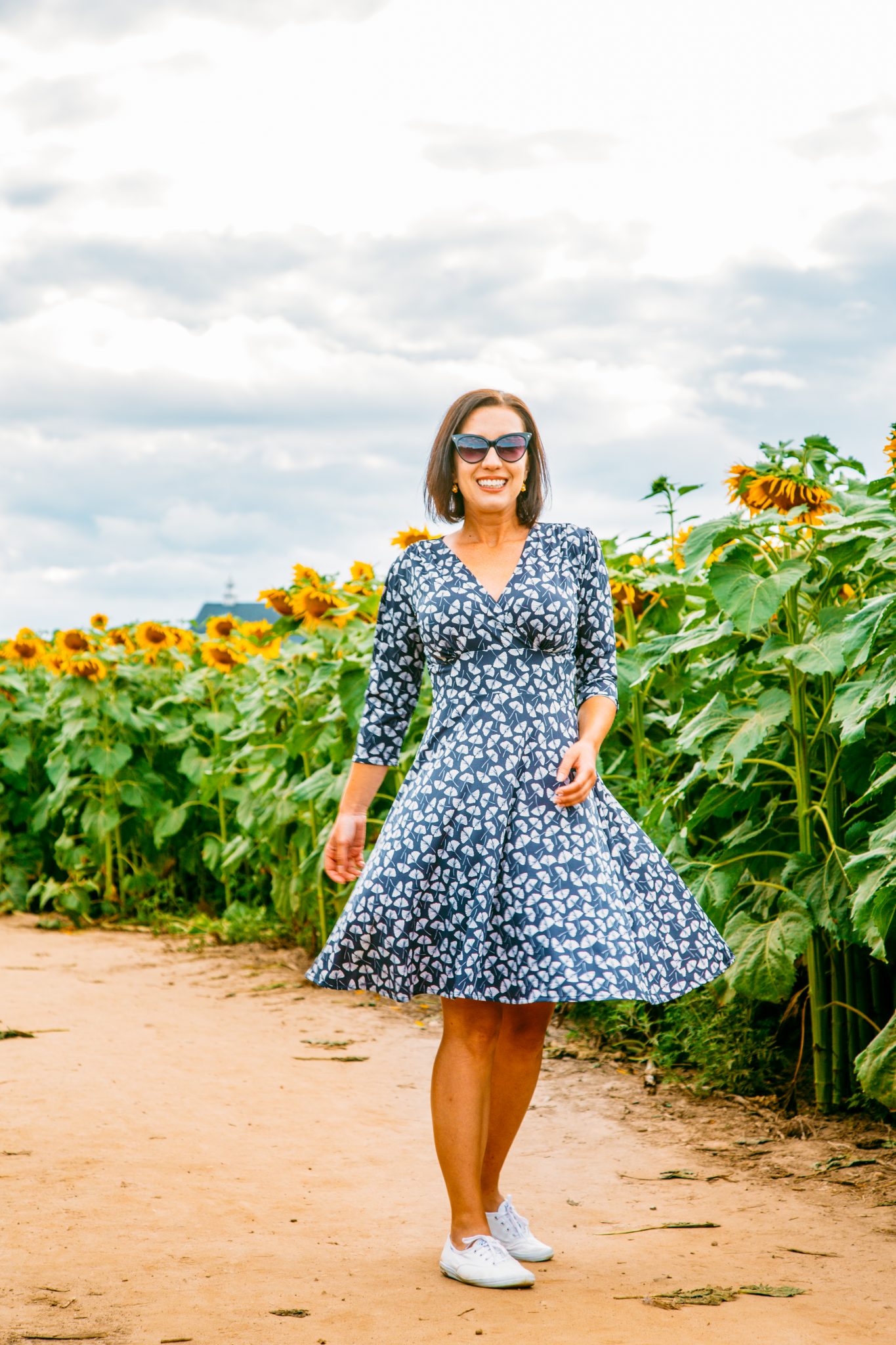 Wearing Karina Megan Dress in a sunflower field in Wisconsin