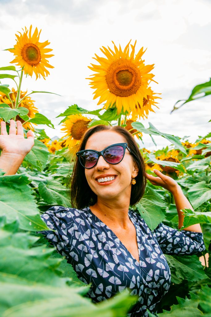 Wearing Karina Megan Dress in a sunflower field in Wisconsin