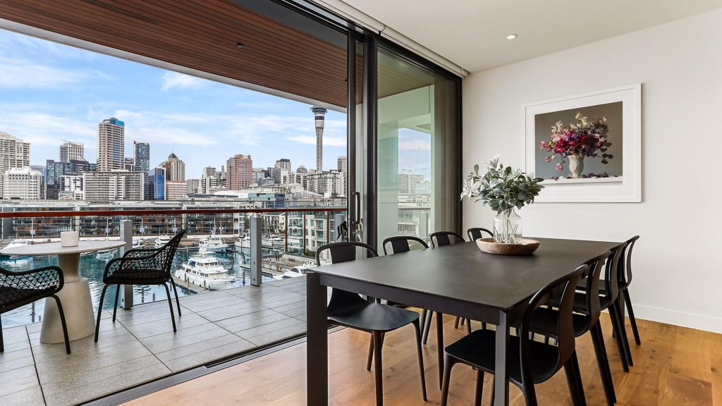 Luxury stay in Auckland, New Zealand featuring large sliding glass door overlooking the city and harbor