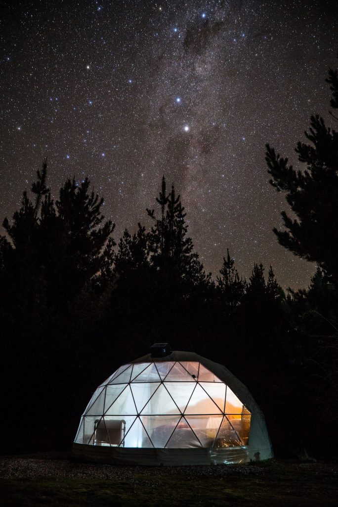 Glamping Honeymoon in Wanaka at night, lit up, with star filled sky above