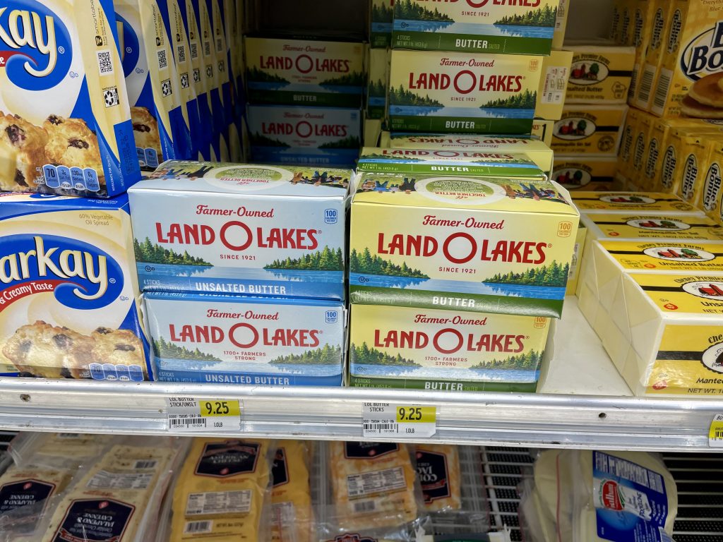 A grocery store shelf with dairy product prices in Turks and Caicos.