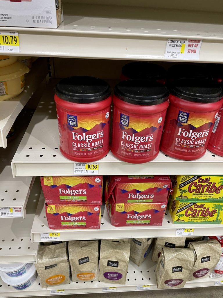 A grocery store shelf with Folgers coffee and prices in Turks and Caicos.