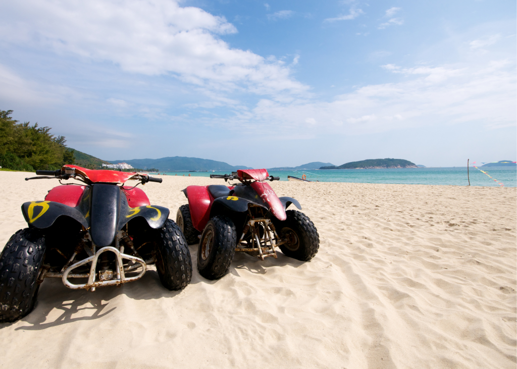 Two atvs parked on the beach.