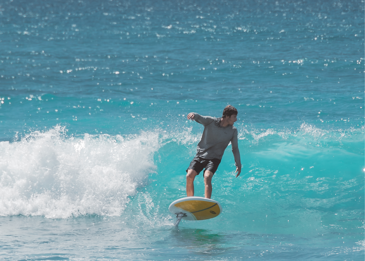  a man riding an E-Foil on the blue waters of Turks and Caicos