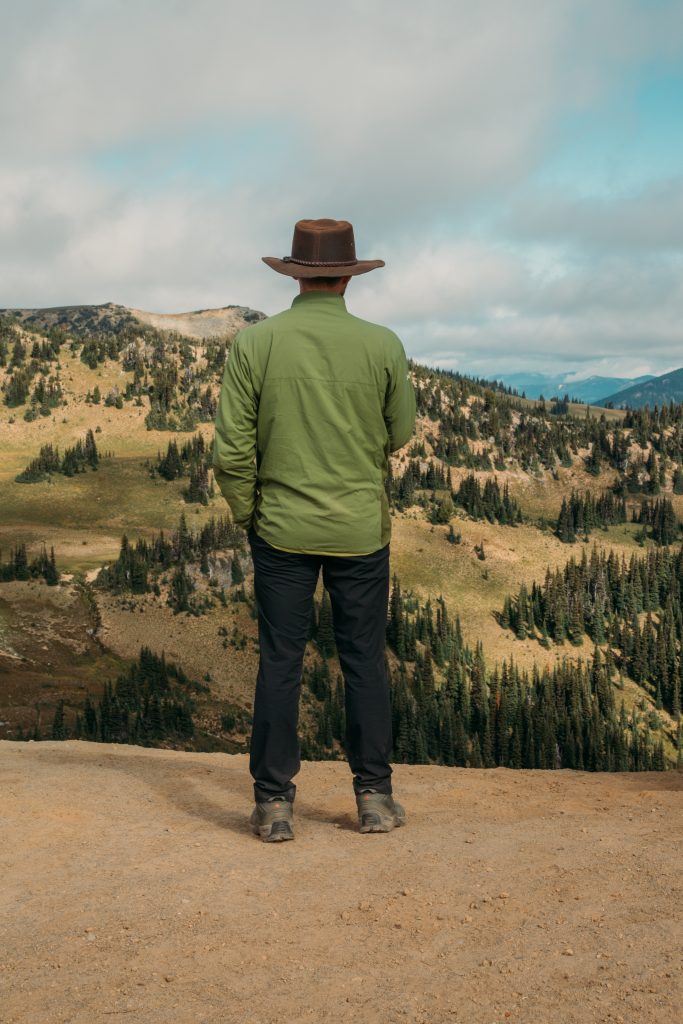 Zac wearing the NxTSTOP Men's Airway Travel Pant Powered by Heiq Hyprotecht in Washington State while hiking.