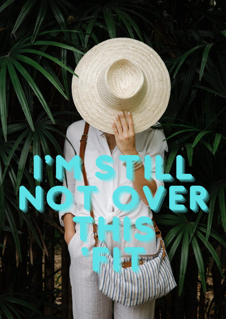 A woman stands surrounded by plants. She's wearing a white linen shirt, gray stripped pants, a cross-body purse, and holds a straw hat in front of her face. Tiffany blue colored text on the image reads,  "I'm still not over this 'fit."