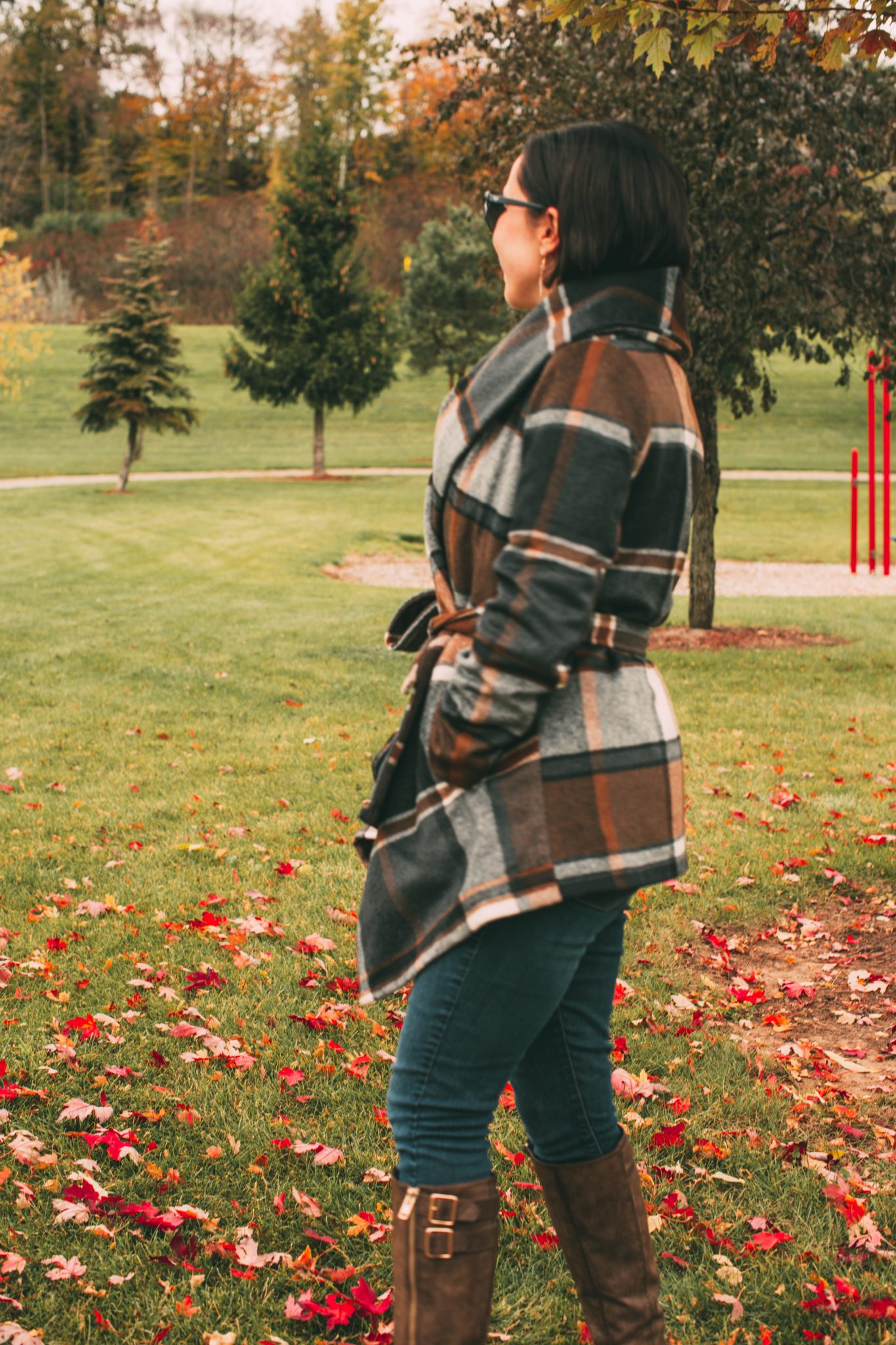 A woman wearing a Prairie Check Rabato Coat by Chicwish.