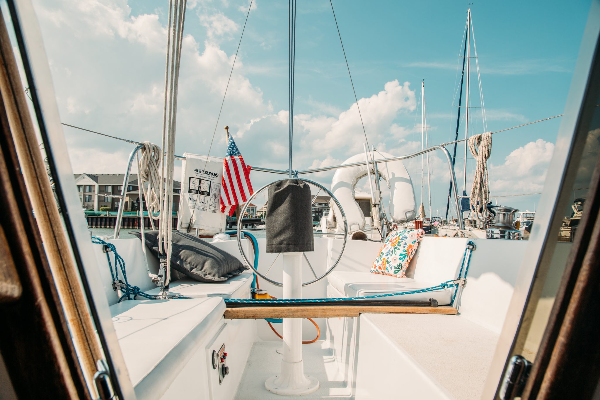 An image taken from onboard the "Clementine" sailboat Airbnb in Racine, Wisconsin, shows the boat's seating area and stern.