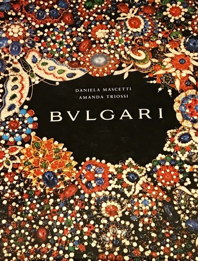 Hardcover fashion and designer book titled Bvlgari Jewellery Coffee Table Book 1st Edition - History Jewellery and Collectibles by Daniela Mascetti and Amanda Triossi with an intricate jewelry set as book cover design