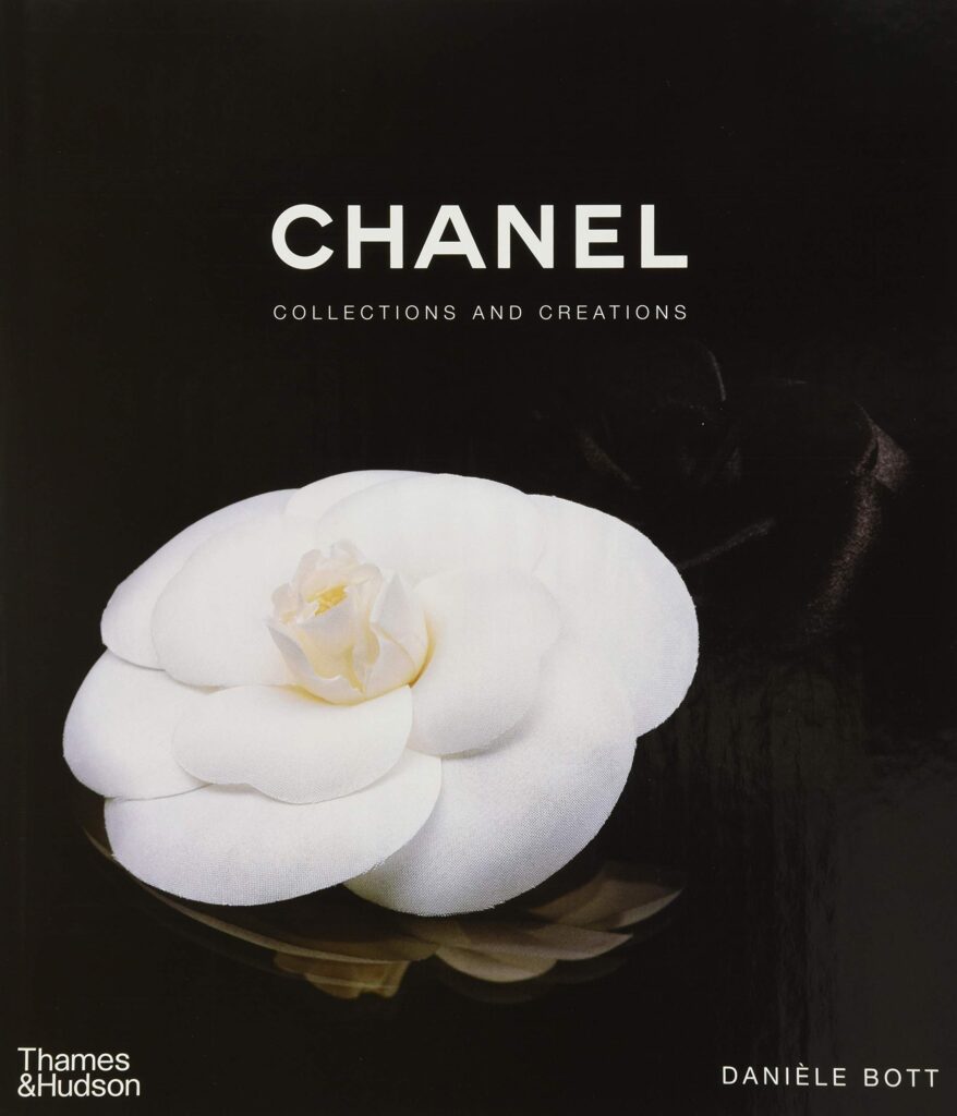 Hardcover fashion and designer book titled Chanel: Collections and Creations by Daniele Bott with a white flower book cover design