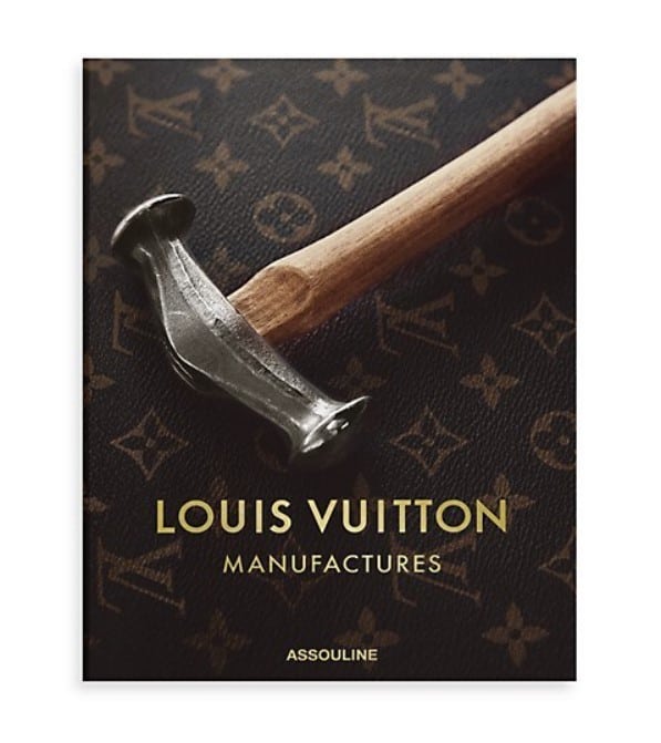 Hardcover fashion and designer book titled Louis Vuitton Manufactures published by Assouline with the brand's signature logo and color as a book cover design