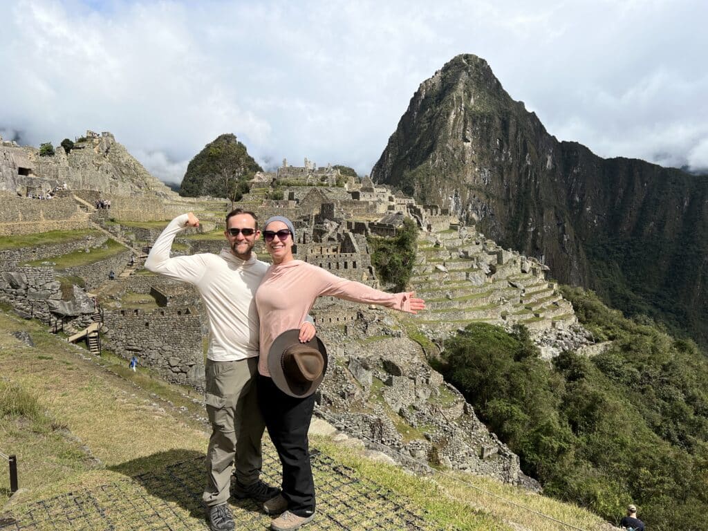 Two people posing for a photo in front of machu picchu wearing eclipse shirts.