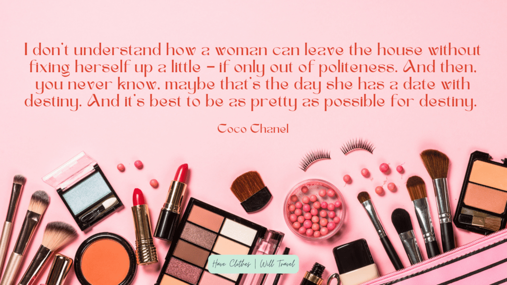 A flatlay of various makeup items on a pink background. Text over the image shares a makeup quote that says, "I don’t understand how a woman can leave the house without fixing herself up a little – if only out of politeness. And then, you never know, maybe that’s the day she has a date with destiny. And it’s best to be as pretty as possible for destiny. – Coco Chanel" 