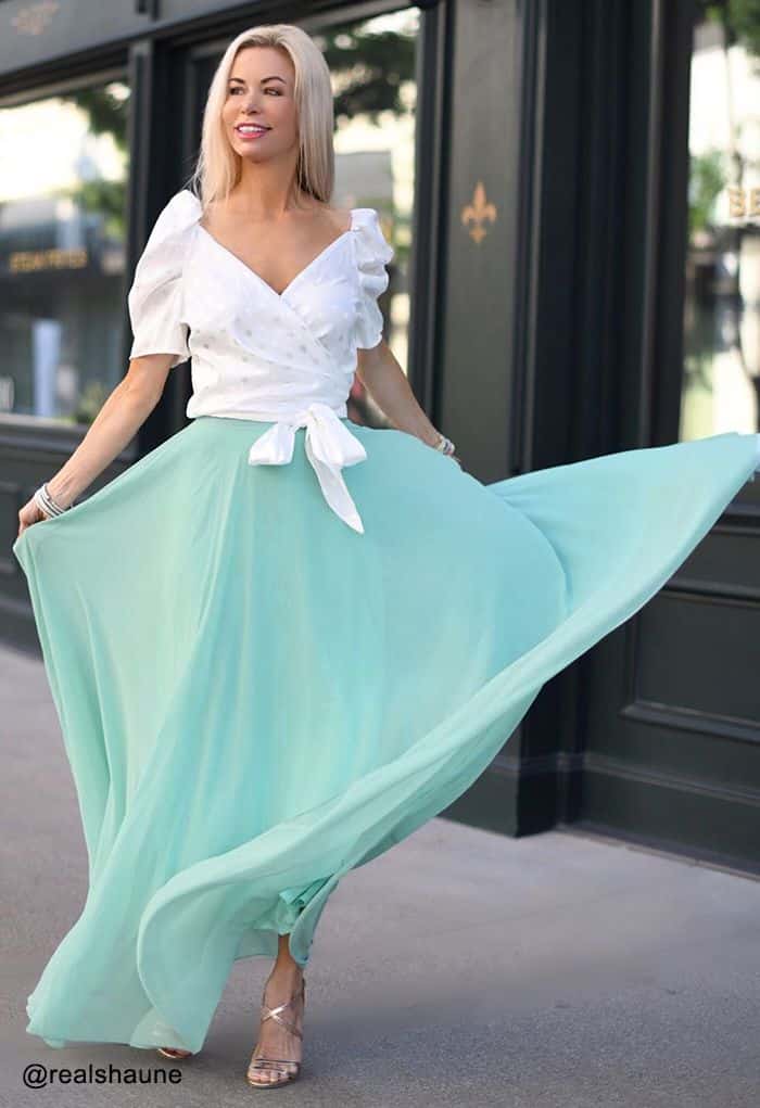 Woman wearing a timeless chiffon maxi skirt in mint green with white top