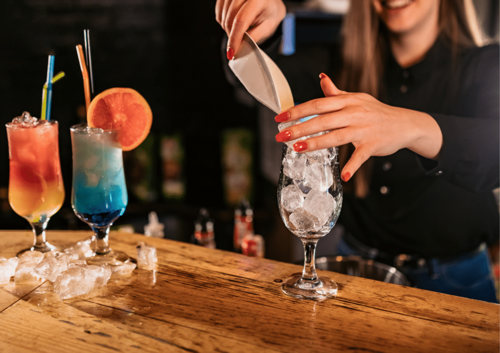 Bartender making fruity cocktails in Curaçao.