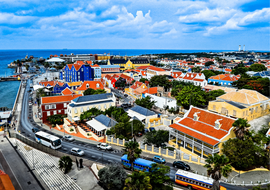 Curacao from above showing building and cars and buses on the highway.