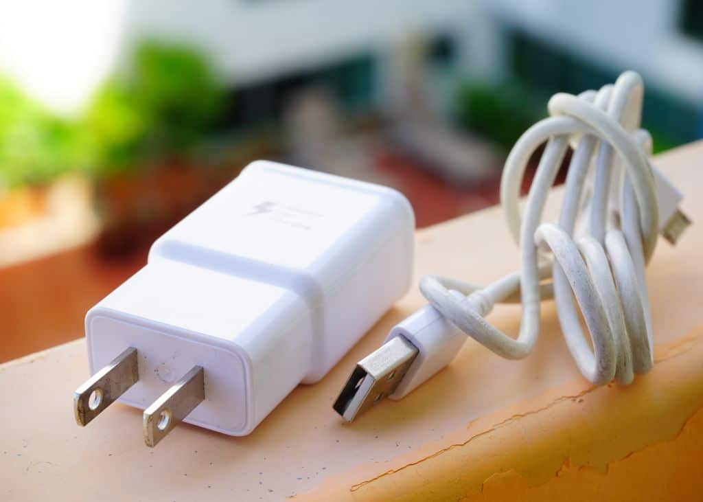 A white usb charger with a cable attached to it.