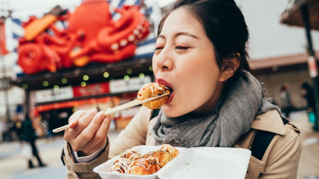 Woman eating japanese street food