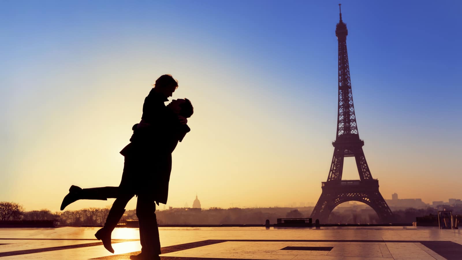 Couple kissing under the eiffel tower in paris france