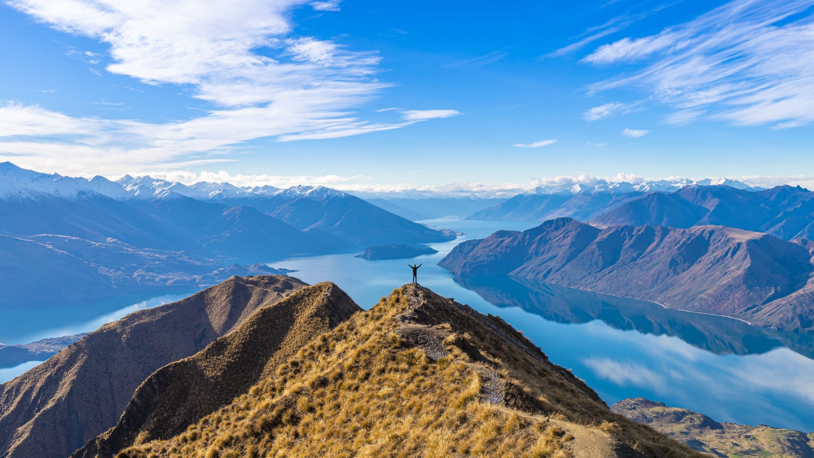 Asian traveler celebrating success at Roy's Peak Lake Wanaka New Zealand