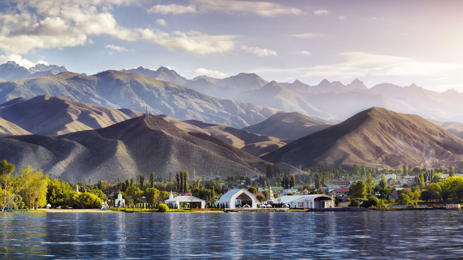 View to Ruh Ordo cultural complex near Issyk Kul lake at mountains background in Cholpon Ata, Kyrgyzstan