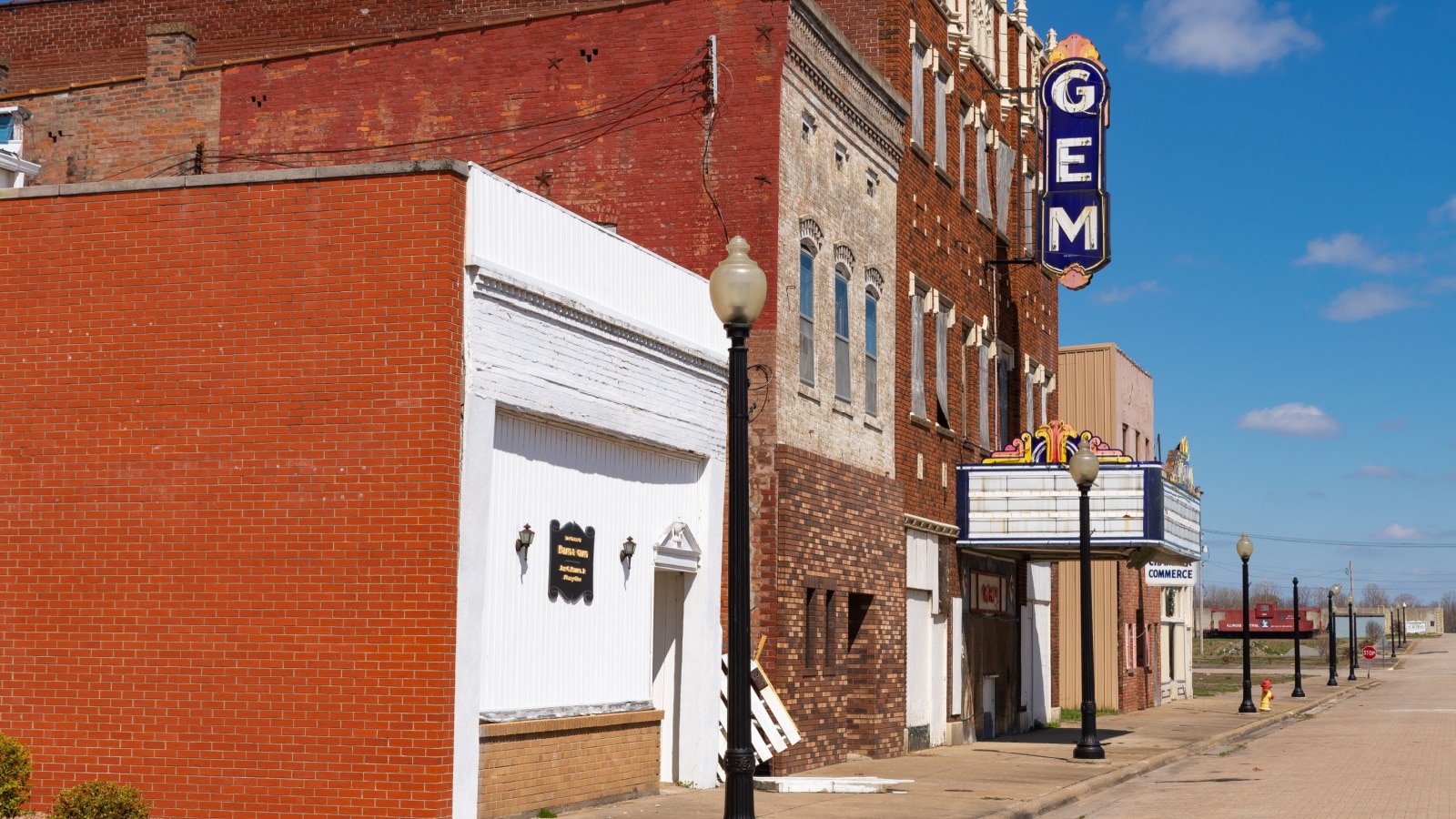 Old brick storefronts and buildings on an empty street in Cairo, Illinois.