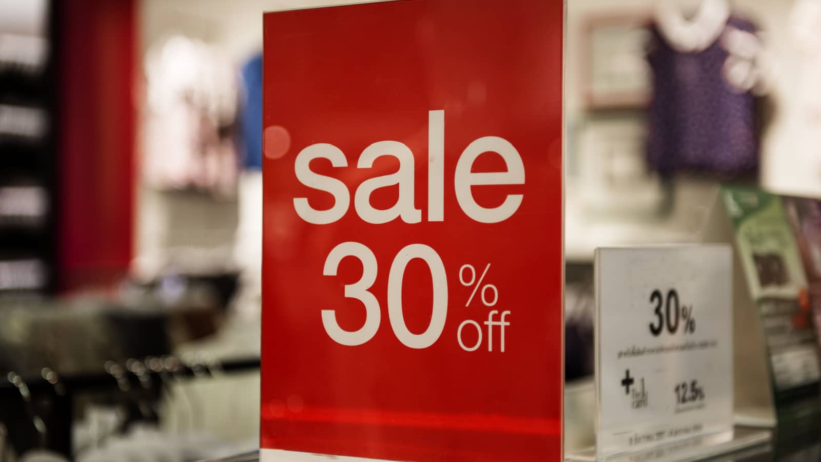 A large red retail sale sign advertising 30% off.