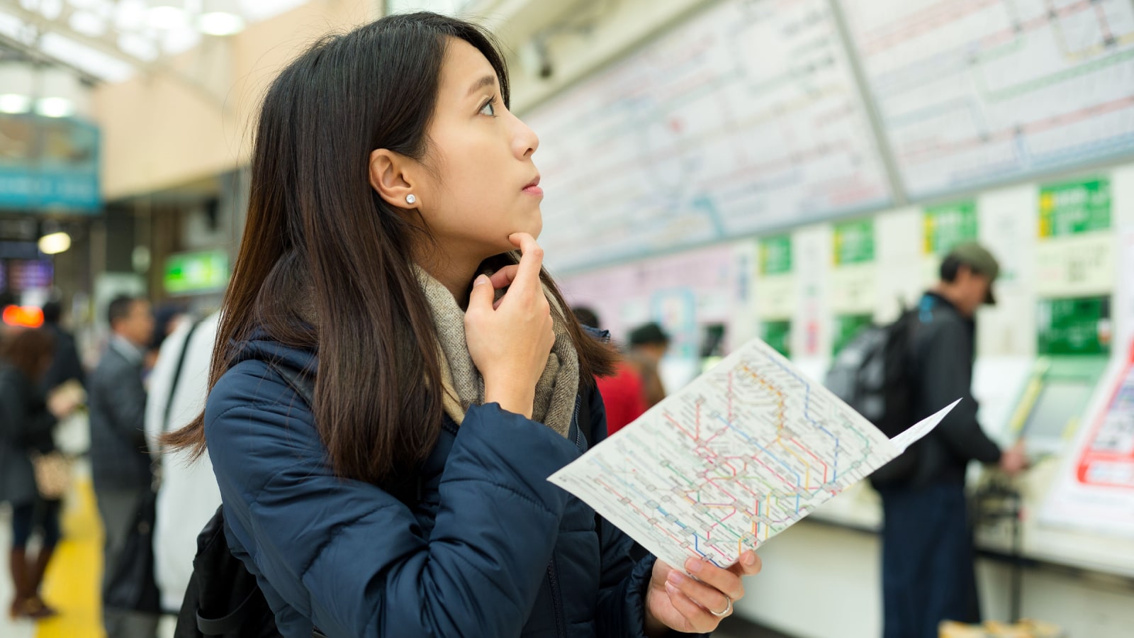 Confused woman look for direction in train station