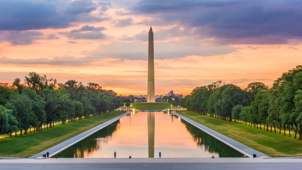 Washington Monument on the Reflecting Pool in Washington, DC, USA at dawn.