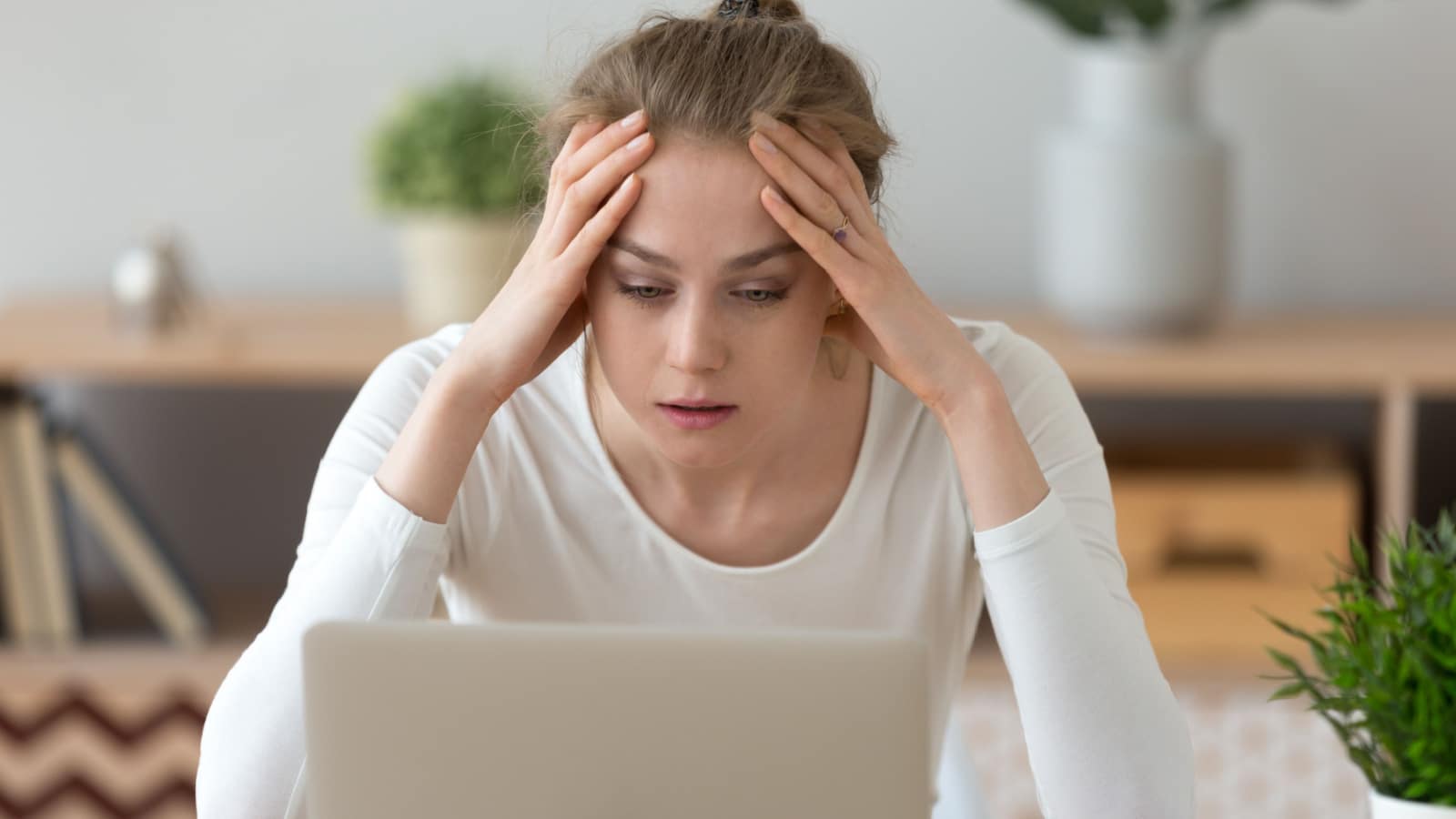 Stressed frustrated young woman student looking at laptop reading bad email internet news feeling sad tired of study work online, upset about problem, failed exam test results, difficult learning