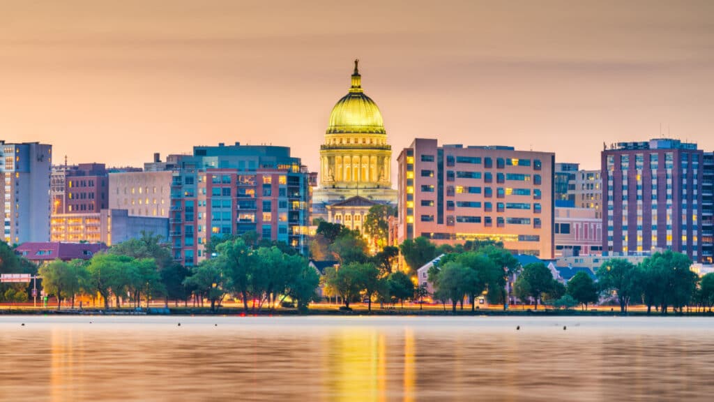 Madison, Wisconsin, USA downtown skyline at dusk on Lake Monona.