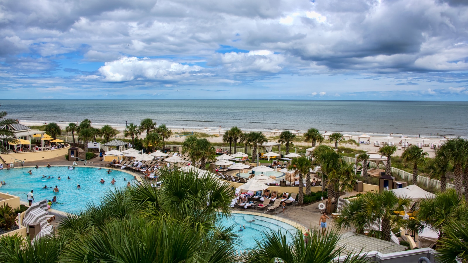 Amelia Island, Florida - August 16, 2019: Tourists enjoying a day in the pool at a luxury resort hotel on Fernandina Beach on beautiful Amelia Island.