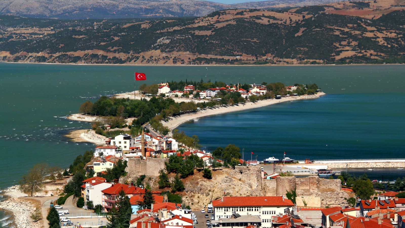 View of the historic part of Eğirdir with its castle in the middle of the lake of the same name and the mountains in the background in the Isparta region of southern Turkey